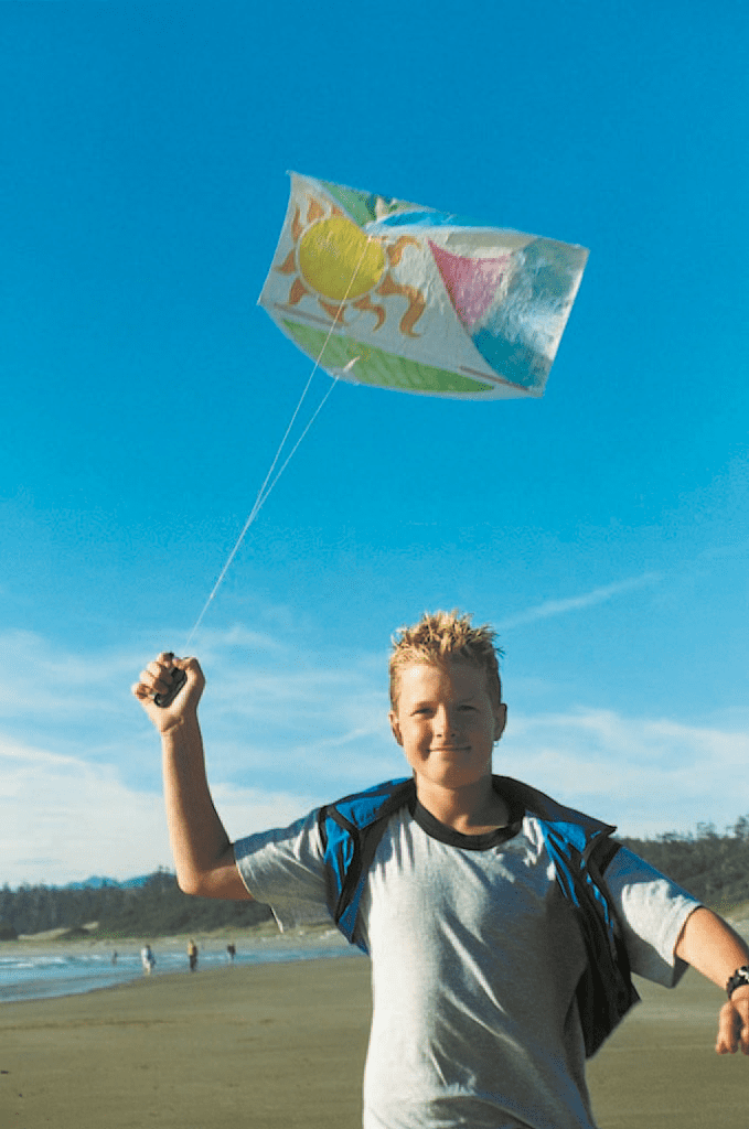 blonde boy on sunny beach flying kite from Kites in the Classroom