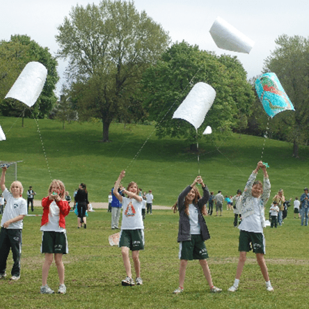 children flying kites as part of school activity